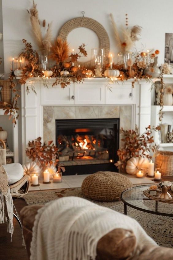 This living room exudes warmth and elegance with its fall-inspired decor. The fireplace mantle is beautifully adorned with an array of pumpkins, dried grasses, and autumnal leaves, all bathed in the soft glow of candlelight. The neutral tones of the room are complemented by the earthy hues of the seasonal decorations, creating a harmonious and cozy atmosphere. The roaring fire adds to the inviting ambiance, making this space the perfect place to curl up with a blanket and a warm drink on a chilly fall evening. It’s the ultimate setting for relaxation and comfort as the leaves change outside.