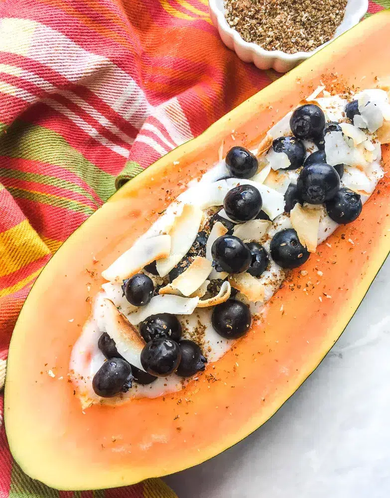 Start your day with a burst of tropical flavors! This Papaya Breakfast Bowl, filled with creamy coconut yogurt and fresh berries, served in a sliced mango, is not only insta-worthy but also gluten-free and vegan. Perfect for a healthy and delicious breakfast! 🌟🥭 #HealthyEats #VeganBreakfast