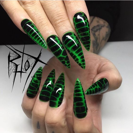 A bold and edgy choice, this nail art design features a striking snake skin pattern in neon green and black. The glossy finish accentuates the vivid colors and intricate design, creating a fierce and dramatic look perfect for anyone looking to make a statement.