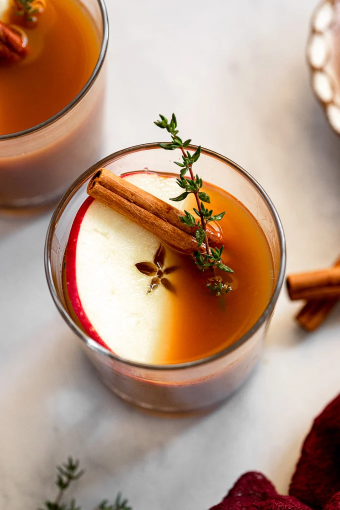 This cozy drink combines bourbon, apple cider, and a splash of maple syrup. Garnish with a cinnamon stick for extra holiday vibes.