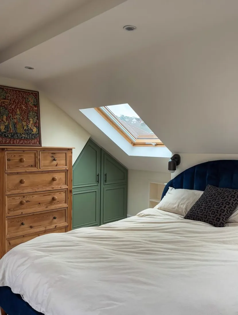 Bold and Bright NookA pop of color transforms this small attic into a lively escape. The teal storage cabinets fit seamlessly under the sloped ceiling, while the mix of textures, like the velvet headboard and wood elements, add depth and character.