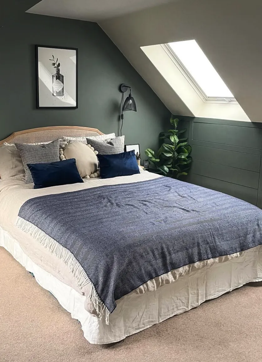 Sage SophisticationThis bedroom combines simplicity and style with a muted green wall and a patterned headboard. The round wicker mirrors add a modern twist, while the layered bedding and soft lighting create a warm, welcoming atmosphere.