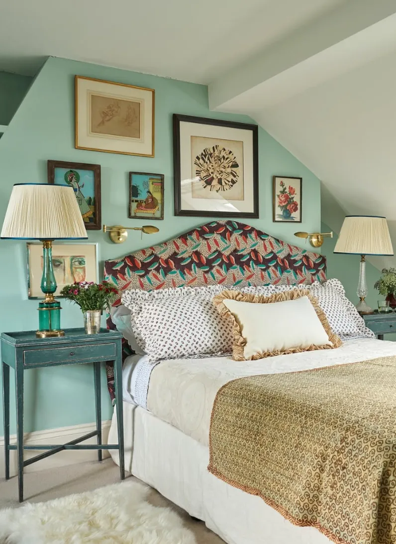 Cozy Green RetreatA soft sage green accent wall paired with a rattan headboard sets a calming tone. The neutral bedding, adorned with gingham patterns and textured cushions, adds layers of warmth. The minimal decor and delicate wall sconces create an inviting, tranquil ambiance.