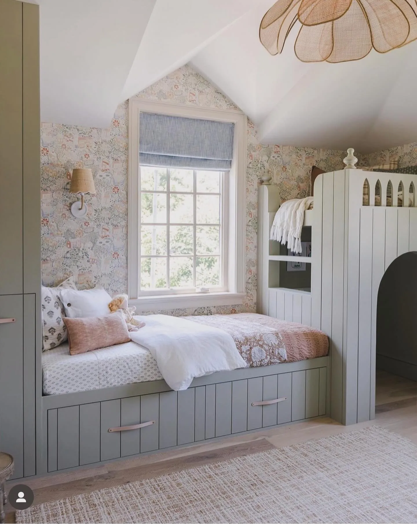 Rustic Meets RefinedA loft bed and built-in daybed make excellent use of vertical space in this attic room. The subtle floral wallpaper and soft pastel tones create a dreamy, layered look while keeping the room functional.