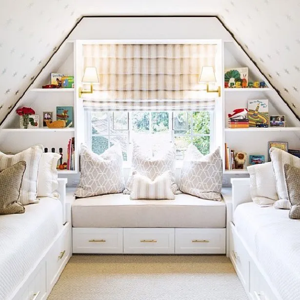 Charming Built-InsThis twin bed setup features built-in shelves and a bench under the window, creating a snug reading nook. The symmetry of the design and natural light make the room feel spacious and inviting.