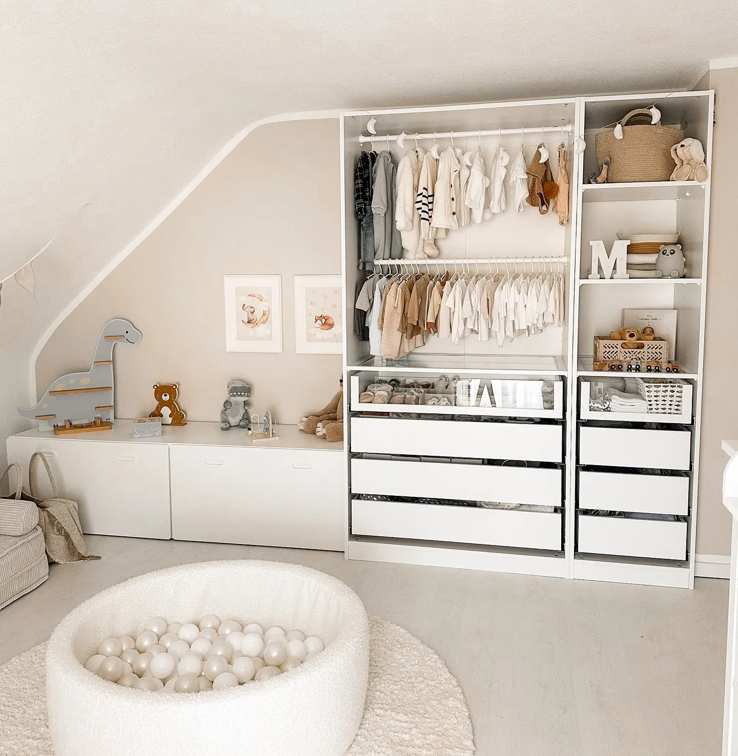 Organized EleganceThis attic room turns storage into a design feature with custom open shelving and drawers. The neutral color scheme and soft textures, like the ball pit and rug, keep the space cozy and kid-friendly while remaining stylish.