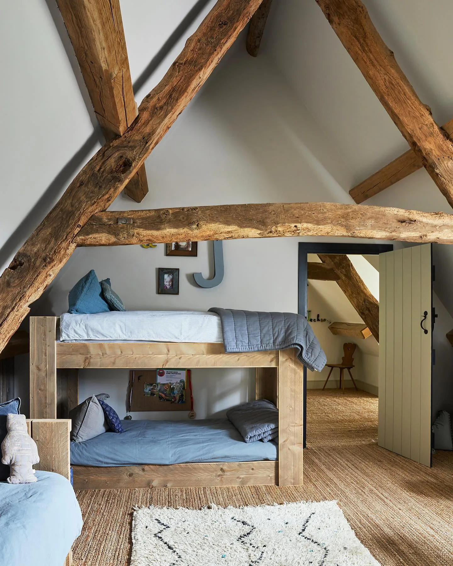 Rustic AdventureExposed wooden beams lend character and charm to this attic space, while sturdy bunk beds make the most of the height. The use of natural materials and neutral tones creates a rustic, cozy retreat perfect for siblings or sleepovers.