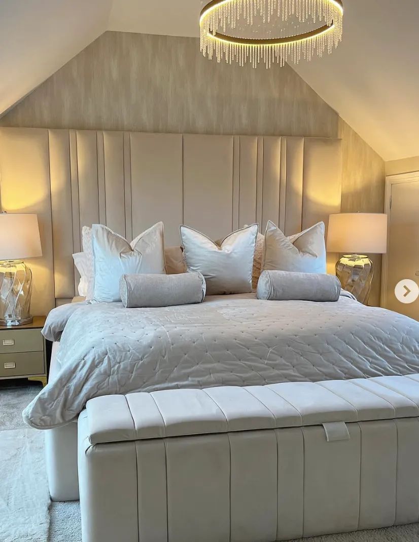 "Luxurious Glow" – Soft creams and plush textures paired with elegant lighting make this attic bedroom a true retreat. The padded headboard wall adds a glamorous touch.