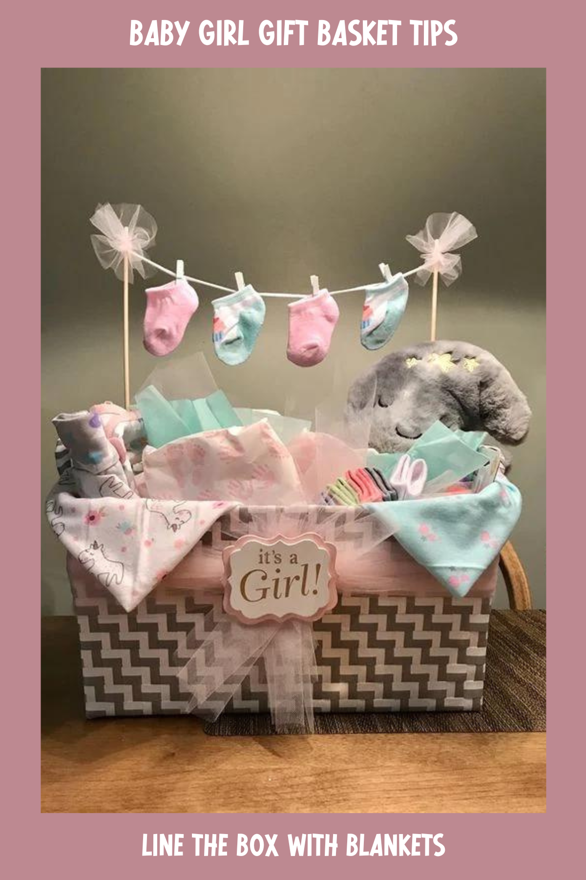 This cute and practical basket comes with an "It's a Girl!" sign and a mini clothesline adorned with colorful socks. It's packed with adorable baby outfits, soft blankets, and toys, providing new parents with a lovely variety of essentials.