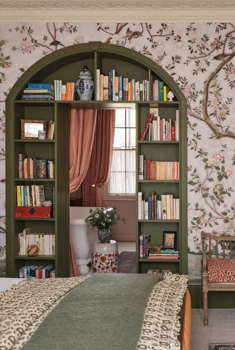 Arched Bookshelf Statement: A bold and dramatic green arched built-in bookshelf serves as a functional statement wall. Framed with wallpaper featuring intricate floral designs, this design creates a cozy library-like ambiance in the bedroom while cleverly incorporating a hidden doorway.