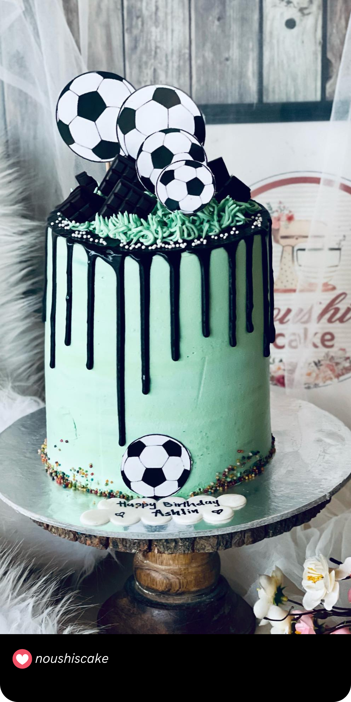 A dream come true for any soccer fanatic! This cake is decked out with soccer balls and a stylish drip effect in black that contrasts against a mint green base. With its sporty look, it’s sure to score big with any birthday celebration.