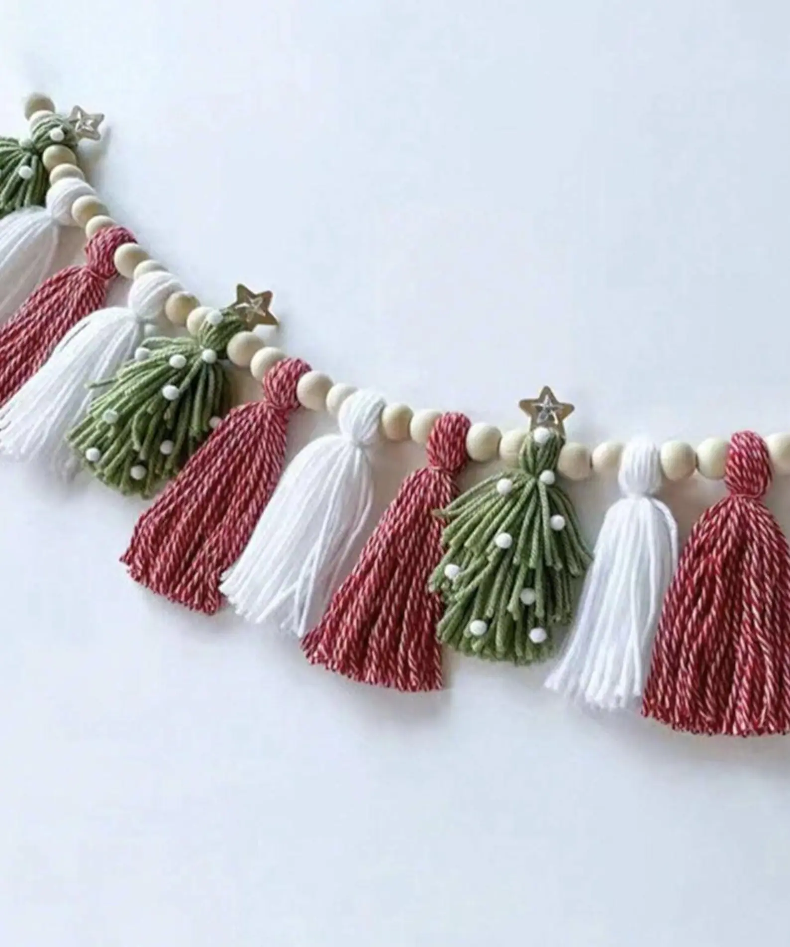 This gorgeous boho Christmas garland is the kind of cozy touch that makes your whole home feel like a handmade holiday dream. The mix of soft tassels, tiny stars, and wooden beads brings that perfect rustic-Scandi balance — simple, natural, and effortlessly stylish. Drape it across your mantel, layer it on your tree, or string it along a shelf for a pop of boho charm that’ll make everyone feel right at home.