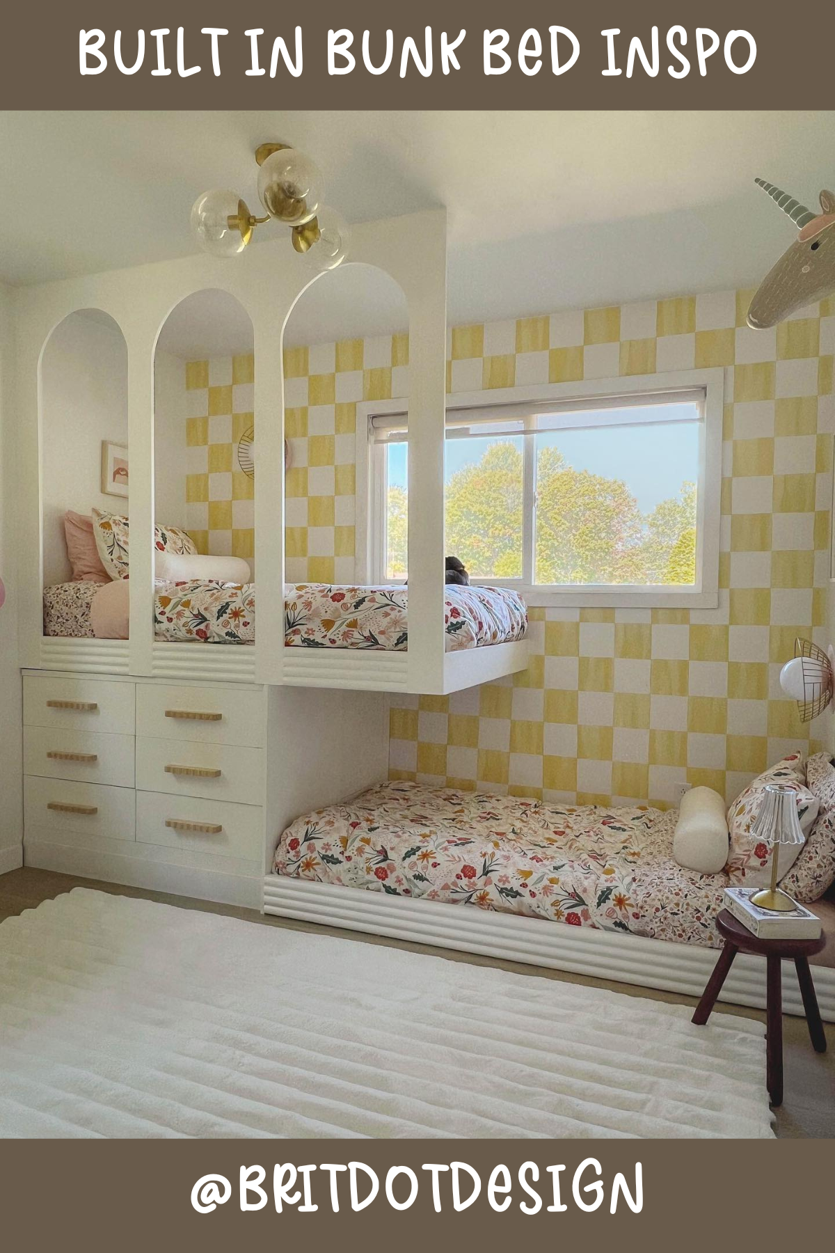 Bright, cheerful, and oh-so-inviting! This L-shaped bunk bed features lovely arches and a built-in set of drawers for extra storage – talk about maximizing space! The floral bedding and yellow checkered wallpaper add a playful pop of color, making this setup both functional and stylish. Perfect for a whimsical, happy room!