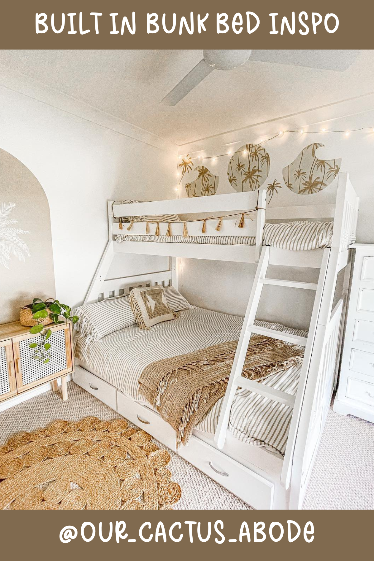 This bed is serving up beachy, boho vibes with its soft neutral tones and natural textures. The full bed on the bottom offers plenty of space to sprawl out, while the single bed on top is perfect for sleepovers or siblings sharing a room. Loving the tassel garland and the tropical wall decals – they add such a playful, relaxed feel to the space!