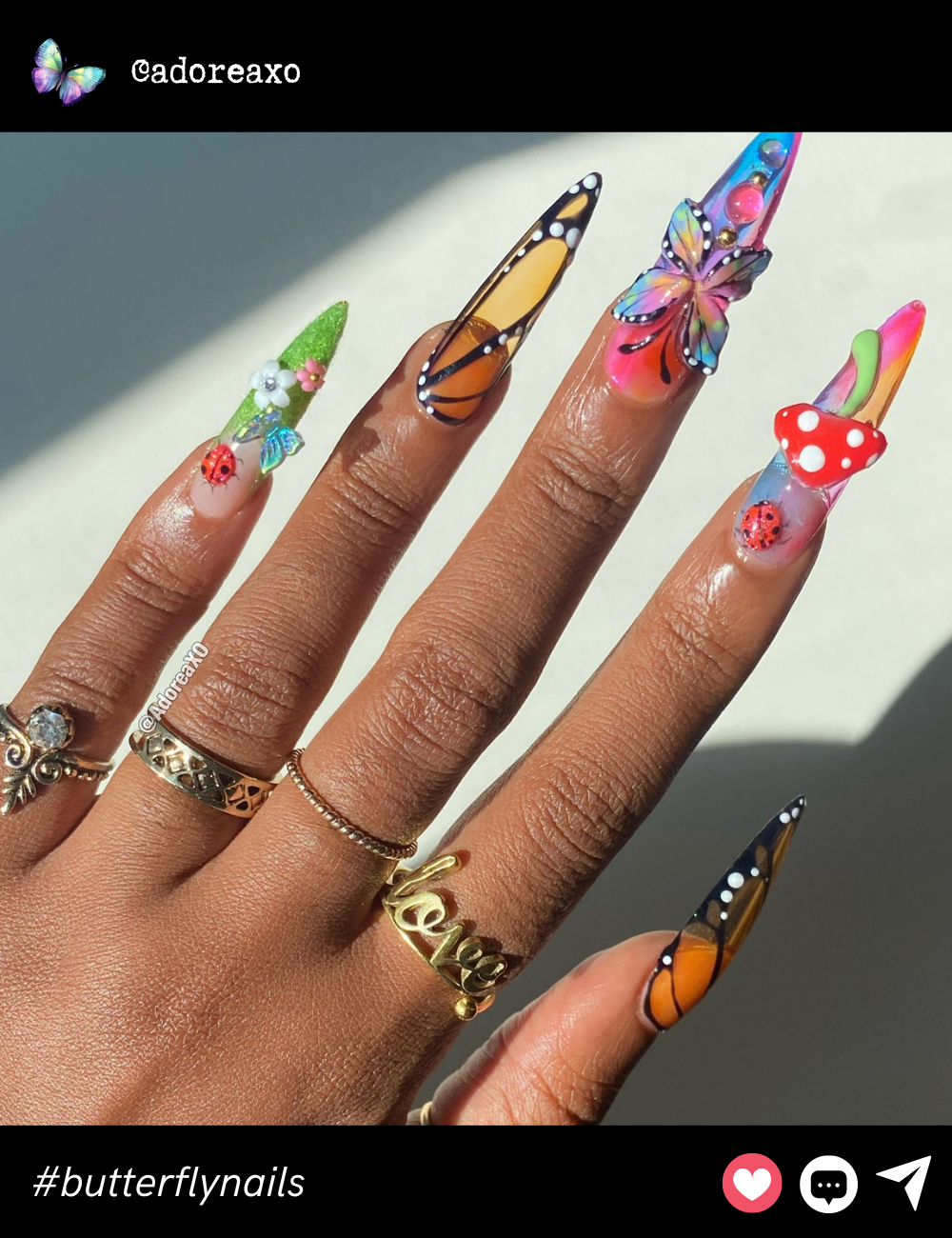 A showstopping 3D butterfly design paired with playful elements like mushrooms and ladybugs, all set against bright, bold nails for a truly unique, nature-inspired look.