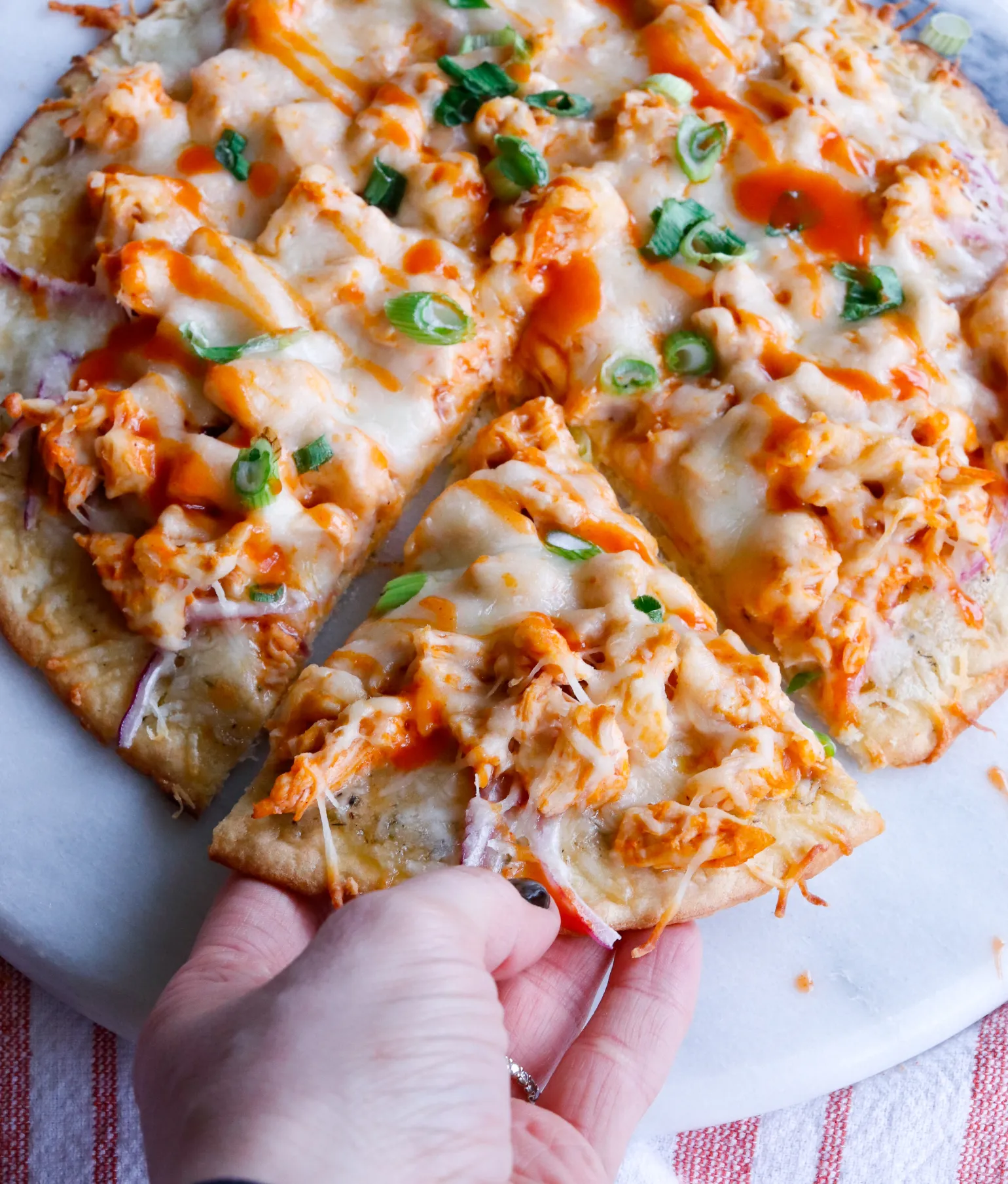 Swap out traditional crust for a cauliflower base, then top with buffalo chicken, red onions, and a light sprinkle of mozzarella. Bake until crispy and enjoy a guilt-free pizza night!