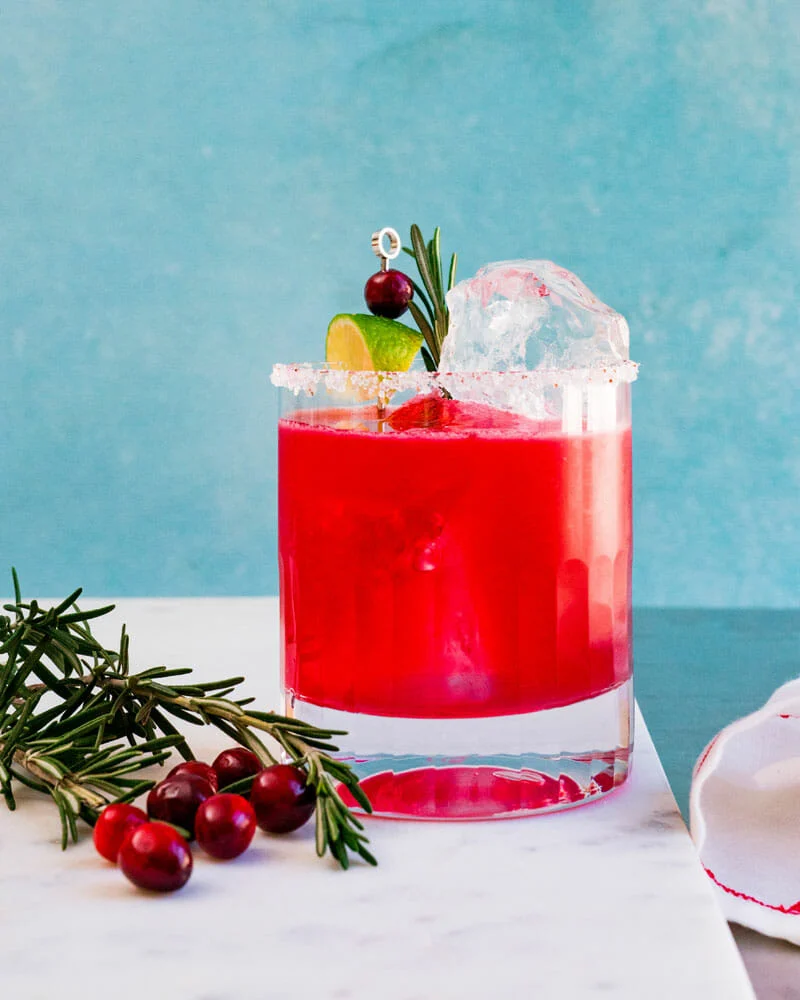 Give this summer classic a festive twist with cranberry juice and a sugared rim. A fun and refreshing addition to your Christmas mixed drinks lineup.