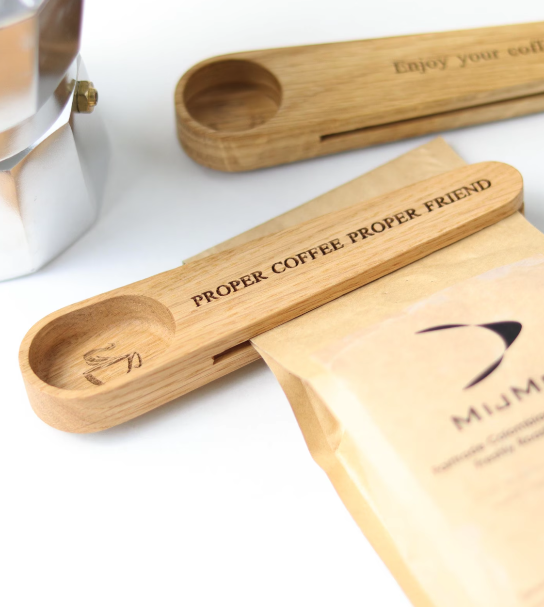 A beautifully crafted solid oak personalised coffee scoop bag clip with optional solid oak coffee tamper and handle-less coffee and espresso cups.