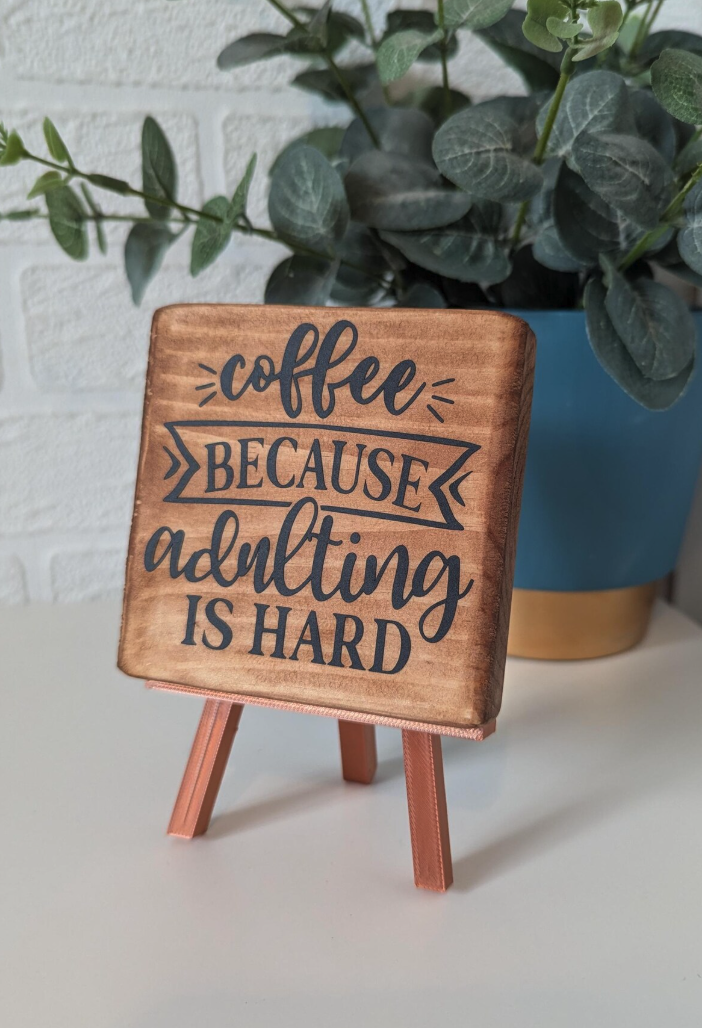 Think framed coffee-themed prints, a “But First, Coffee” sign, or even a coffee bar organizer for their brewing station. It’s a gift that’s both practical and Pinterest-worthy.