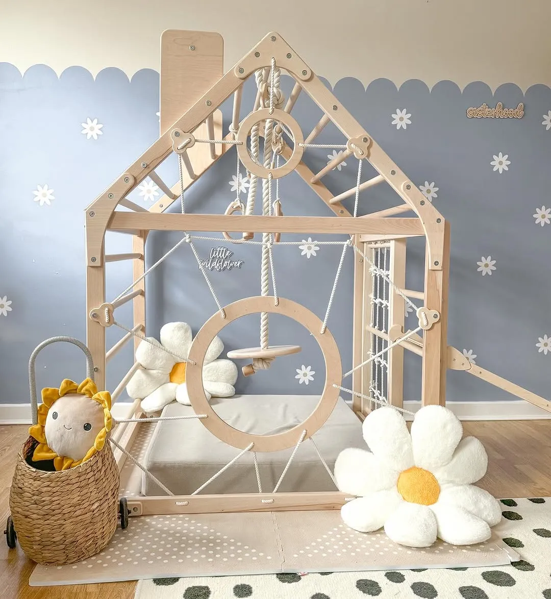 "Climbing Fun with a Floral Touch" – This indoor climbing frame combines adventure with charm, featuring ropes, a swing, and soft daisy cushions. It’s a playful haven with a touch of whimsy!