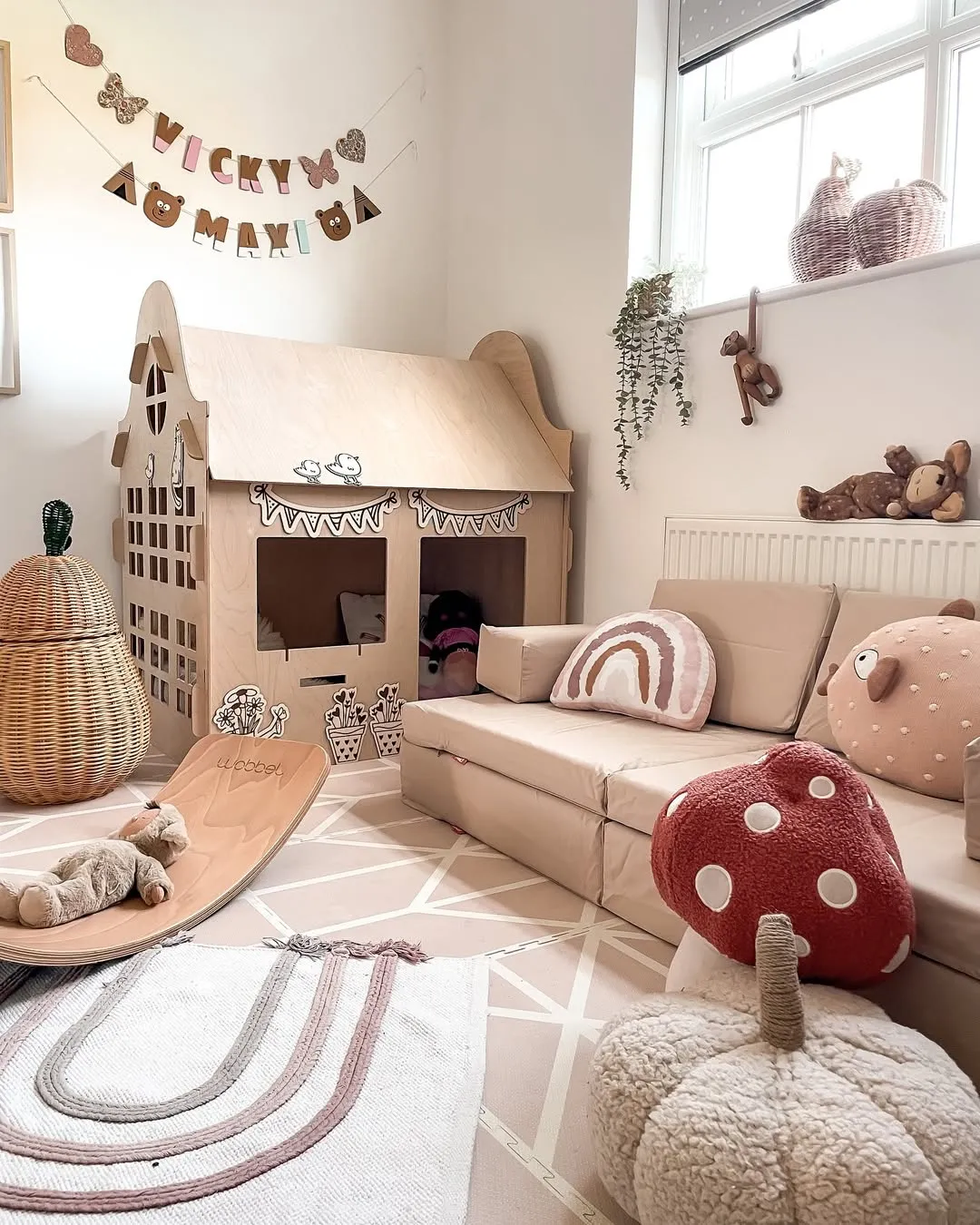 "Imaginative Hideaway" – This wooden playhouse, paired with soft rainbow accents and plenty of pillows, is a dream come true for kids who love pretend play.