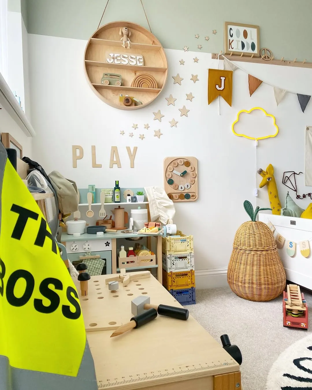 "DIY Dreamland" – A playful setup with a mini workshop, adorable banners, and storage crates makes this space both practical and fun for little builders.