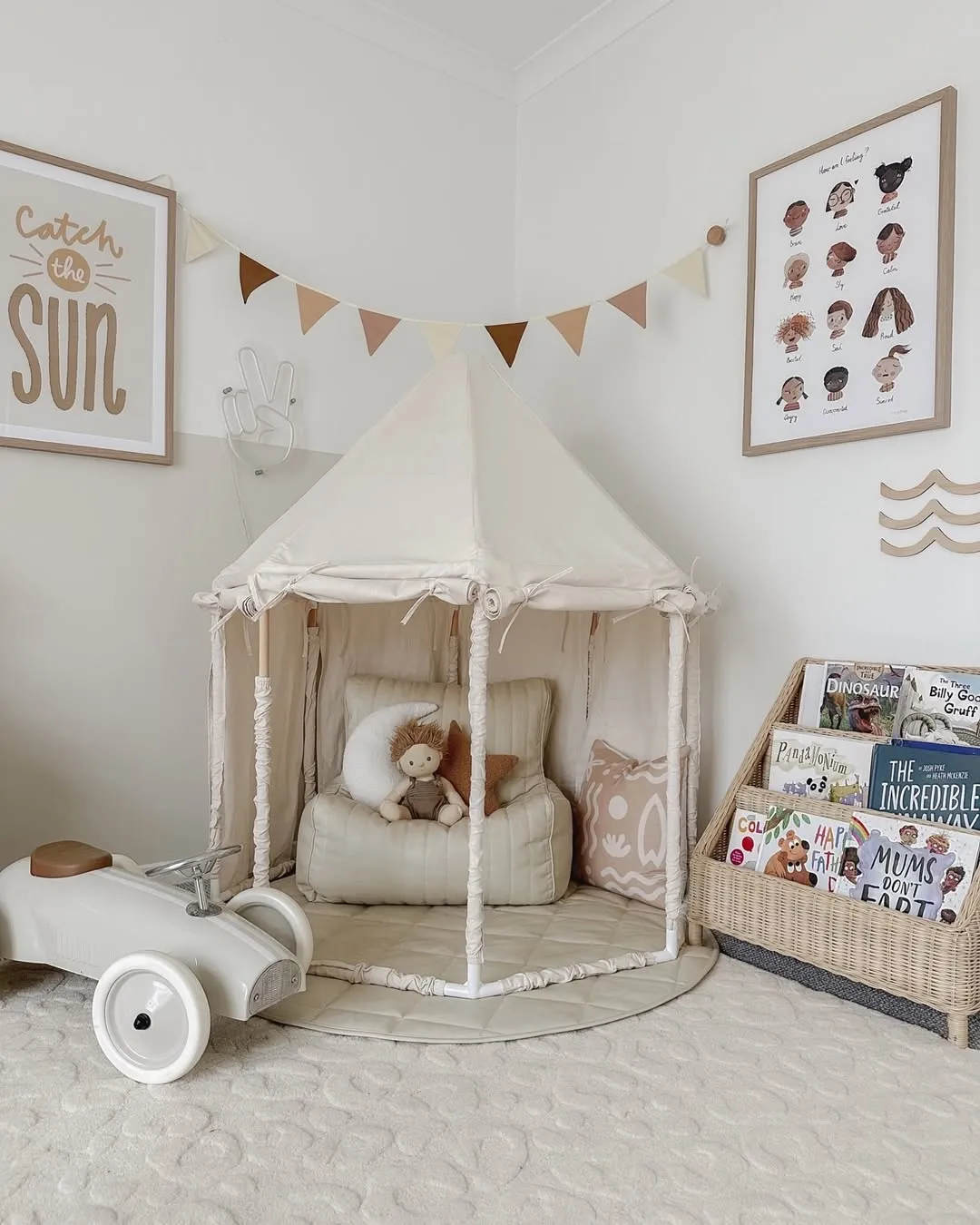 "Cozy and Calm" – A play tent nestled in the corner with soft cushions and a book basket offers a peaceful retreat. The bunting adds the perfect playful touch!