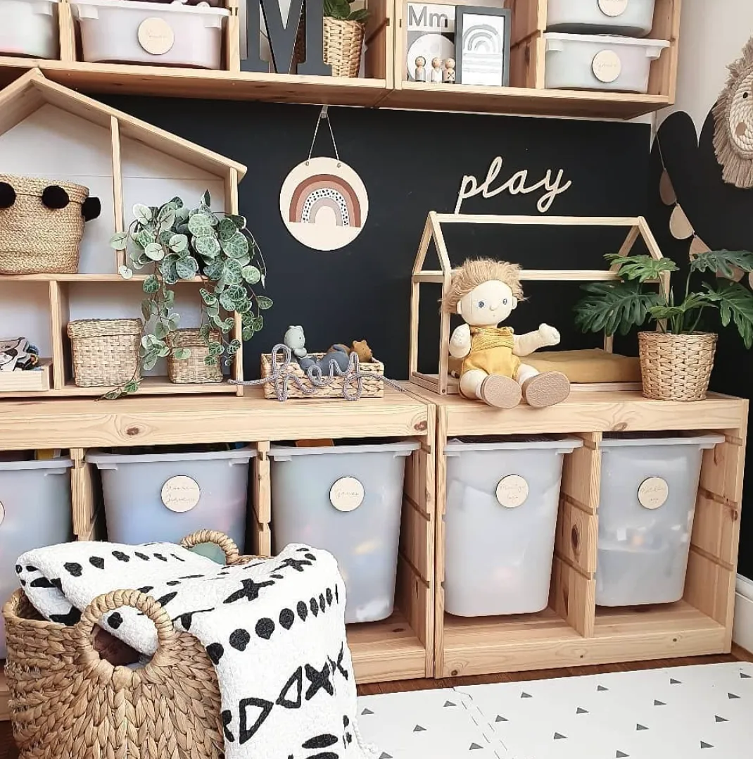 Natural Play Station – This playroom embraces warm wooden tones with plenty of storage bins and open shelving for an organized, minimalist vibe. The house-shaped decor adds charm while keeping the space functional and tidy.