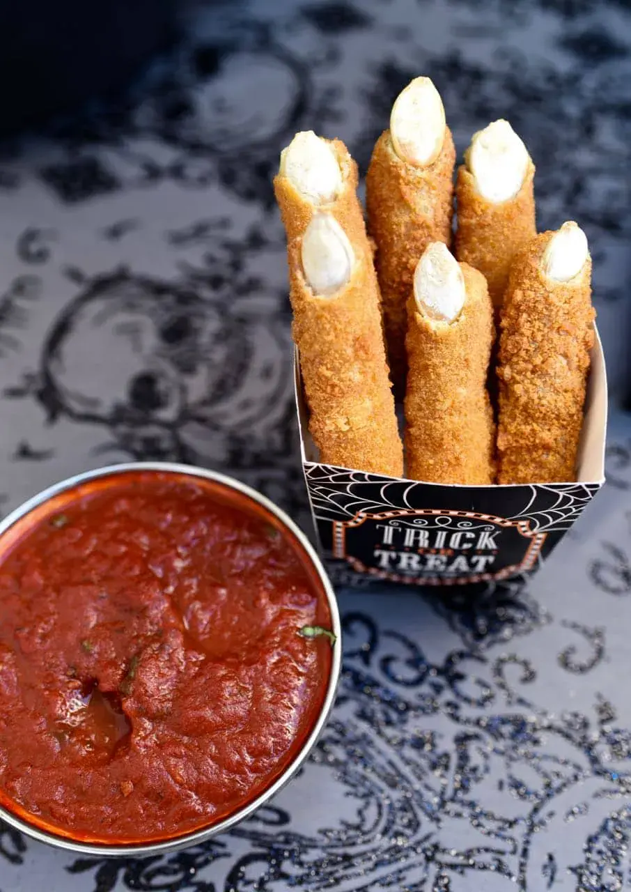 Mozzarella sticks get a spooky glow-up with almond fingernails and a crispy crumb coatingâserve with marinara for a bloody dipping effect!