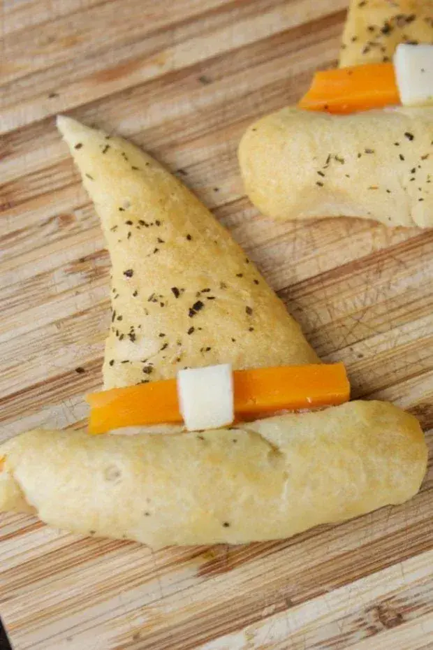 Flaky, buttery crescent rolls are shaped into cute witch hats and topped with a cheese buckleâeasy, savory, and totally party-worthy.