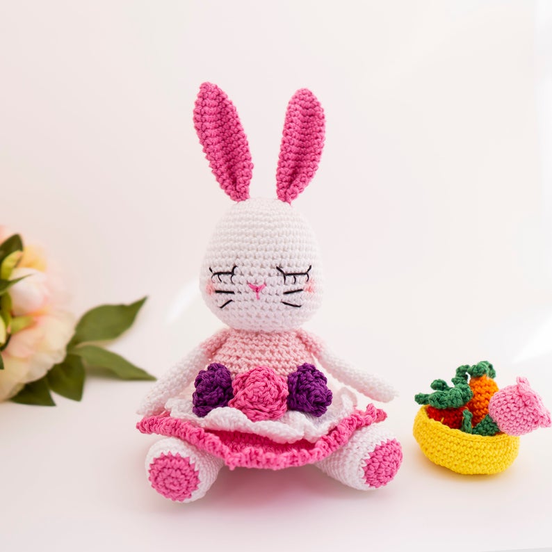 How cute is this Easter Bunny doll? She'll make the perfect gift for a child this Easter and you can crochet her by following the amigurumi pattern