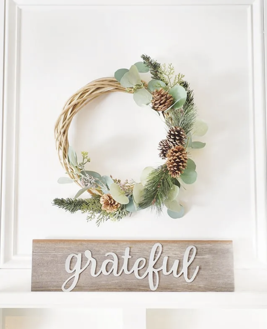 Bring the magic of a winter wonderland to your front door with this charming, snowy wreath design. A lovely choice for winter decor lovers. Make it here.