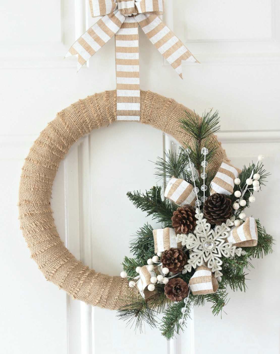 For a rustic, vintage-inspired holiday, this burlap wreath adds warmth and charm to any front door. A great budget-friendly project! Get the tutorial.