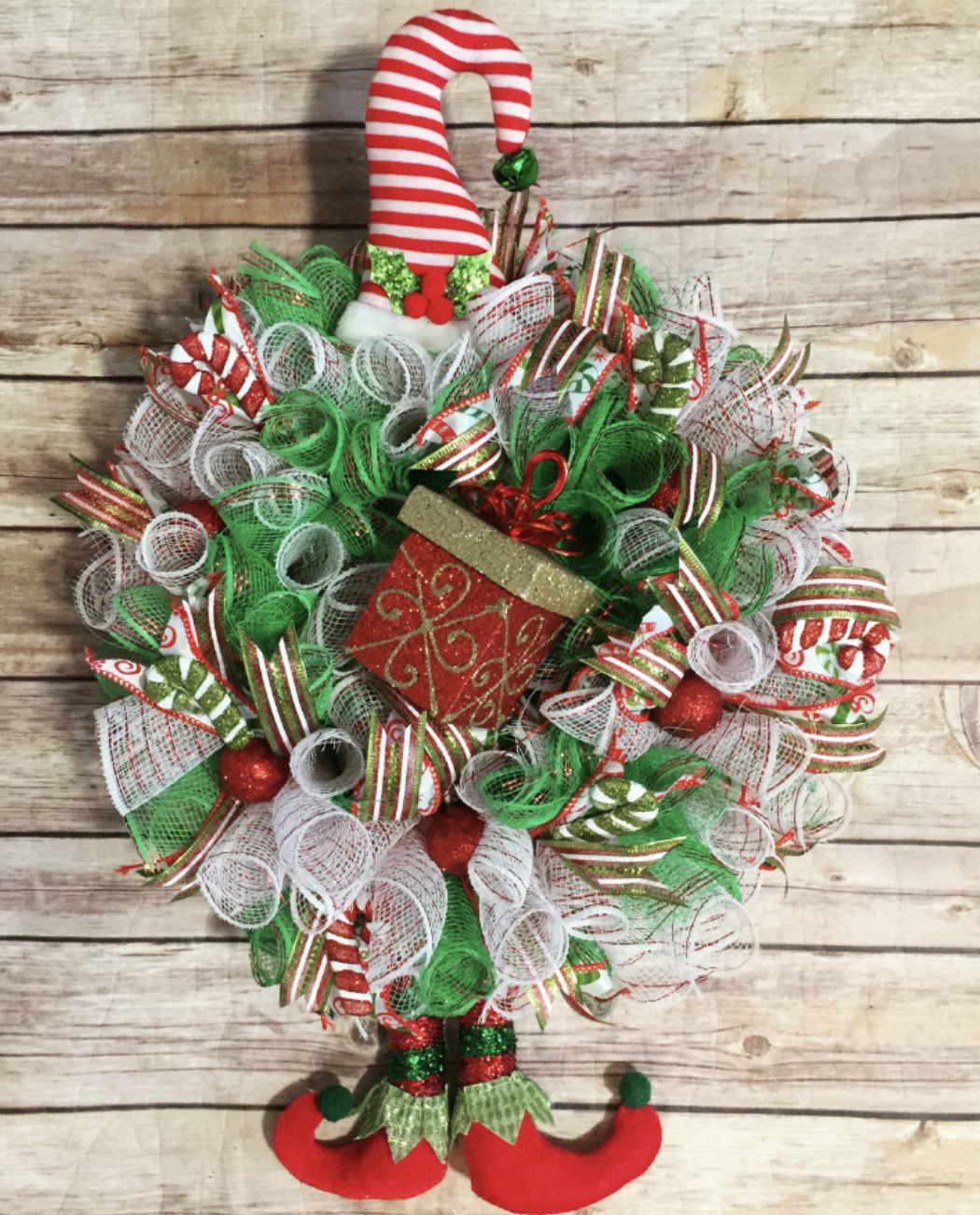 Bring some holiday cheer with this adorable Mini Elf Wreath! Made with an 8-inch Dollar Tree wreath form, it’s a small but festive decoration that’s perfect for adding a playful touch to any room. Make it here.