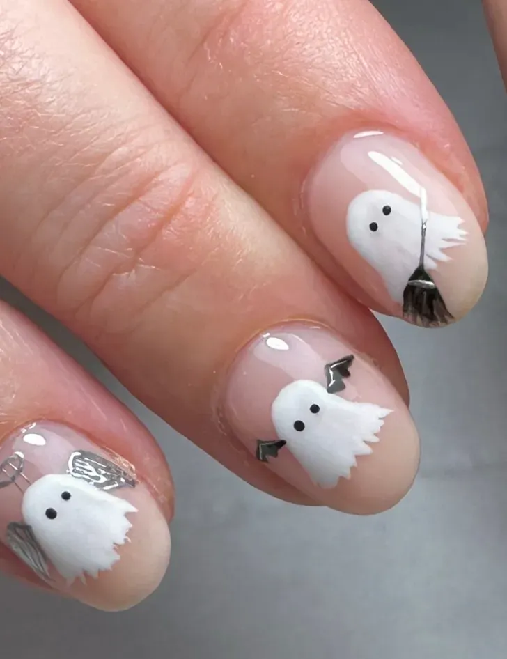 Mini Ghost Friends – Sweet little ghosts with angel wings and brooms make these easy October nails fun to try at home.