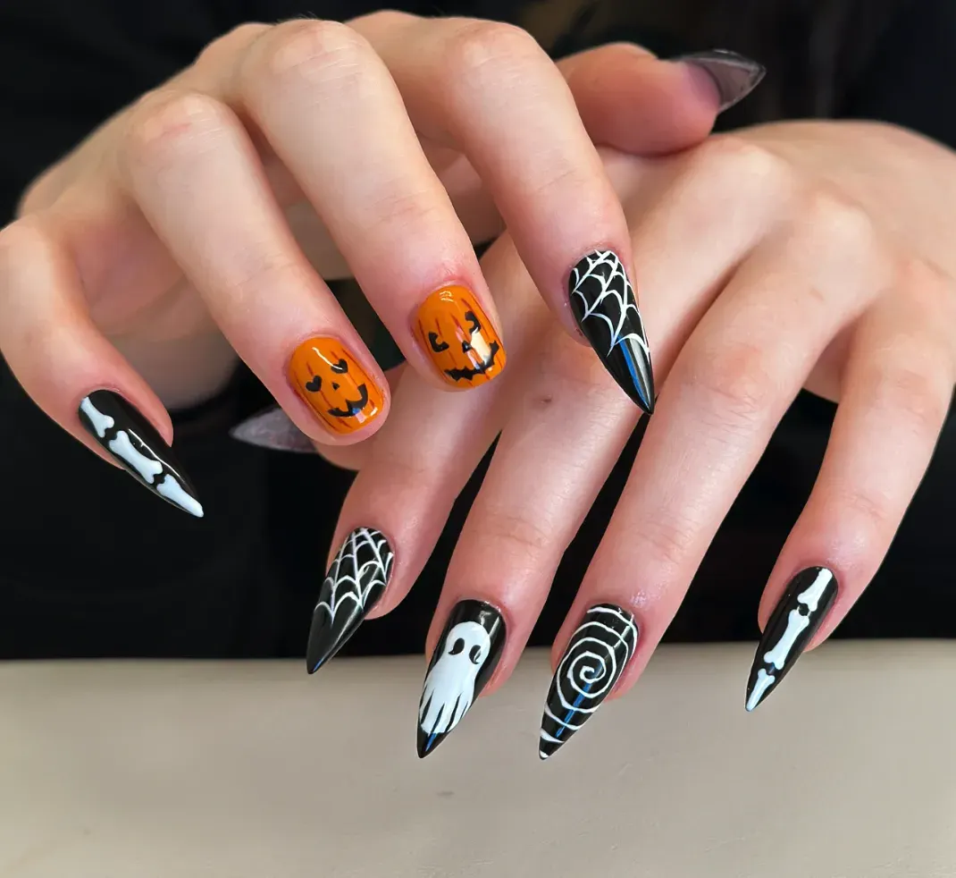 Creepy Cute Mix – Long stiletto nails with ghosts, webs, pumpkins, and bones—DIY spooky nails that pop.