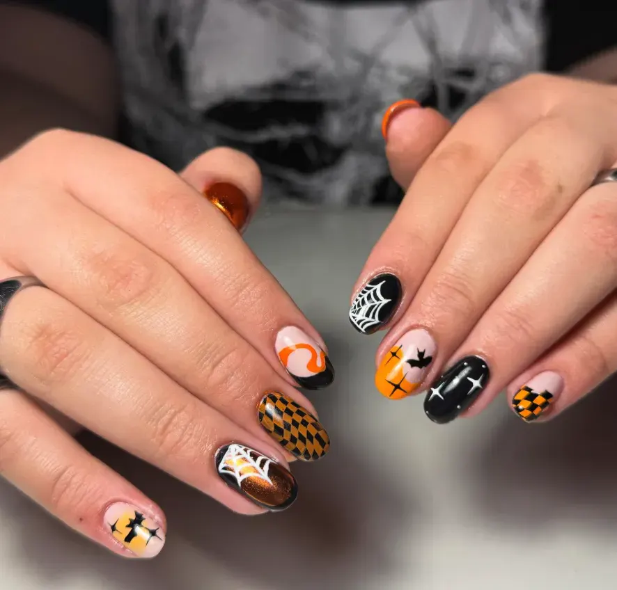 Retro Spooky Set – Checkerboard, webs, and orange swirls come together for DIY spooky nails that feel fun and chic.