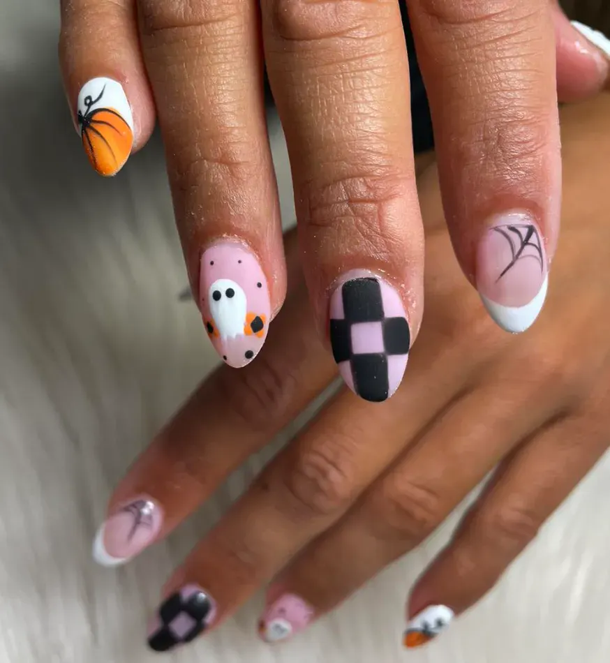 Pumpkin & Ghost Mix – Easy October nails with pumpkins, ghosts, and checkerboard accents you can recreate at home.