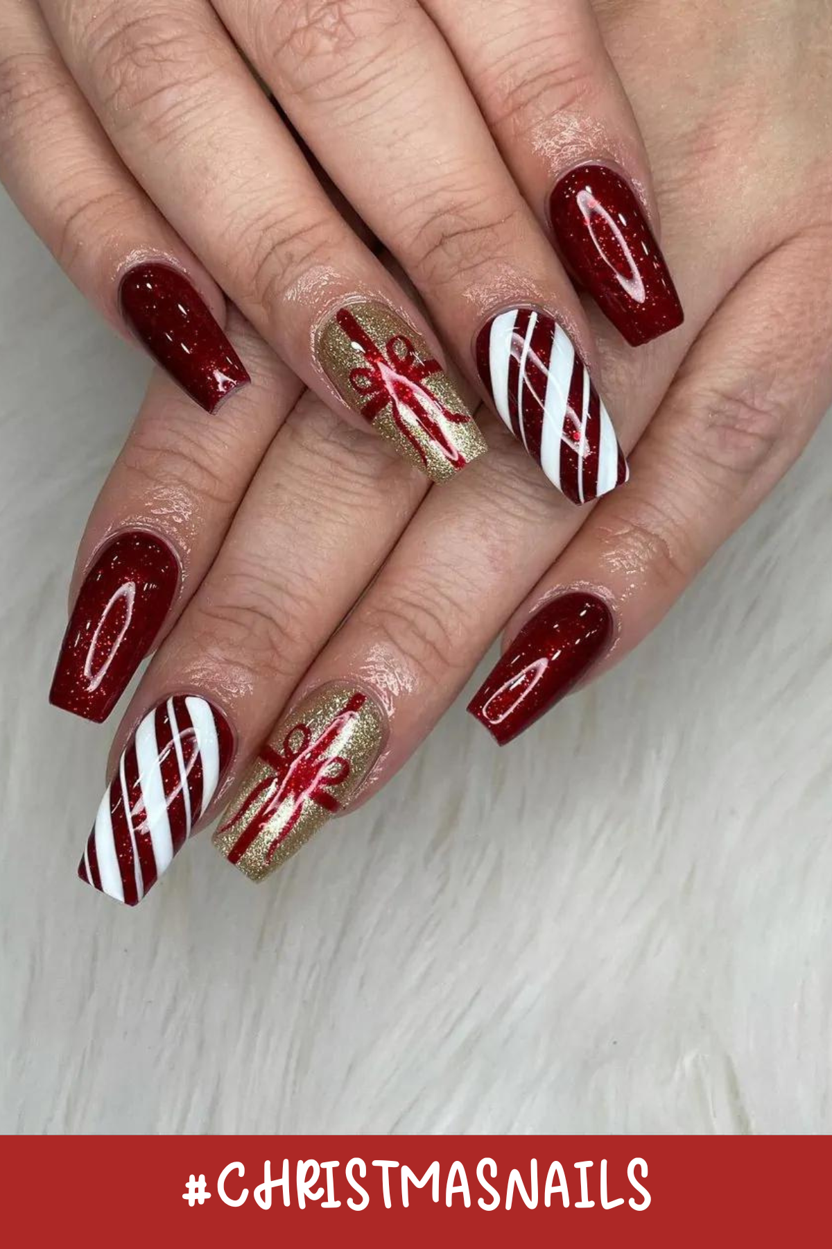 These candy-cane-inspired nails are an absolute holiday treat! With their sparkling red polish, gold presents, and fun striped designs, they’re the definition of festive fun for your hands.