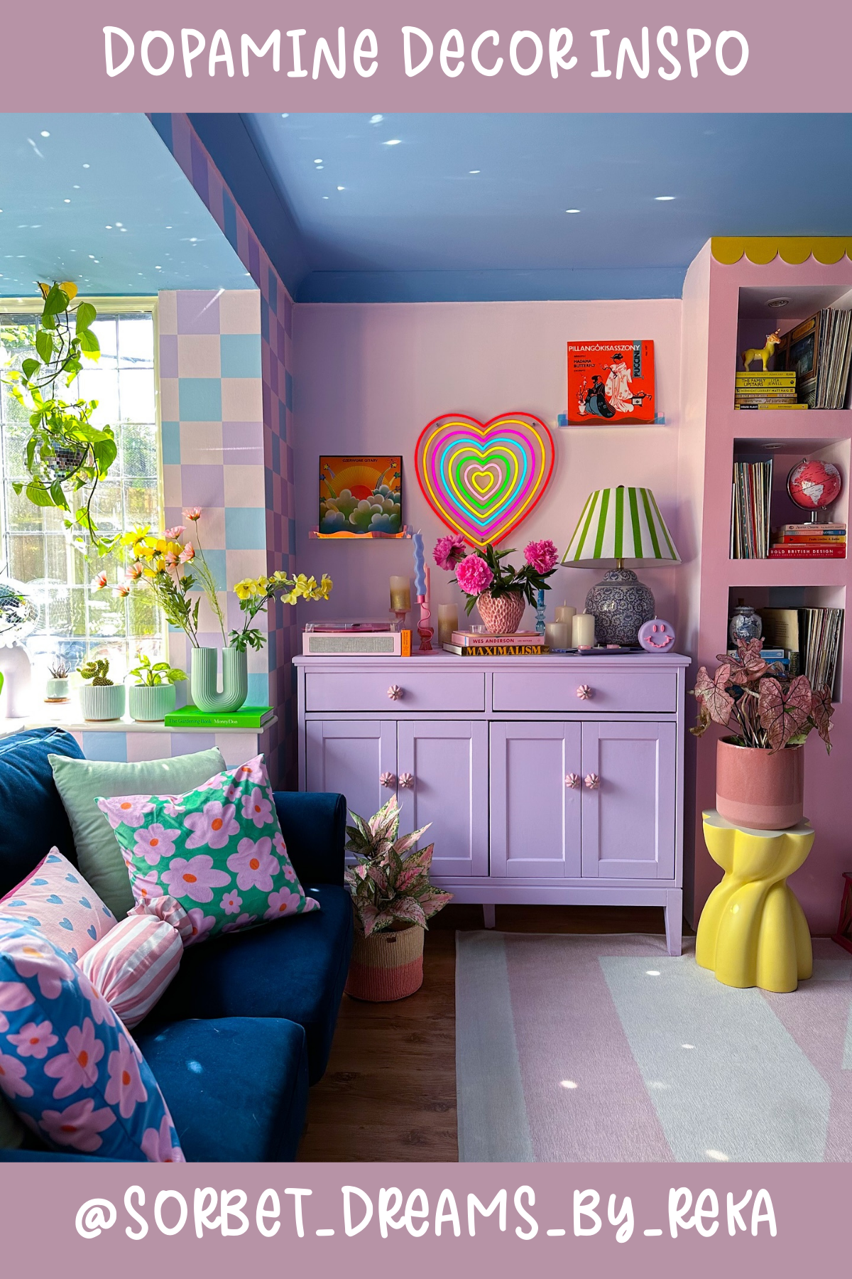 @SORBET_DREAMS_BY_REKAIt's like stepping into a candy store! 🍭 This space is drenched in pastels and topped off with a rainbow heart light that screams joy. The checkered wall, pink cabinet, and mix of plants make it both bold and inviting – the perfect place to daydream and relax.