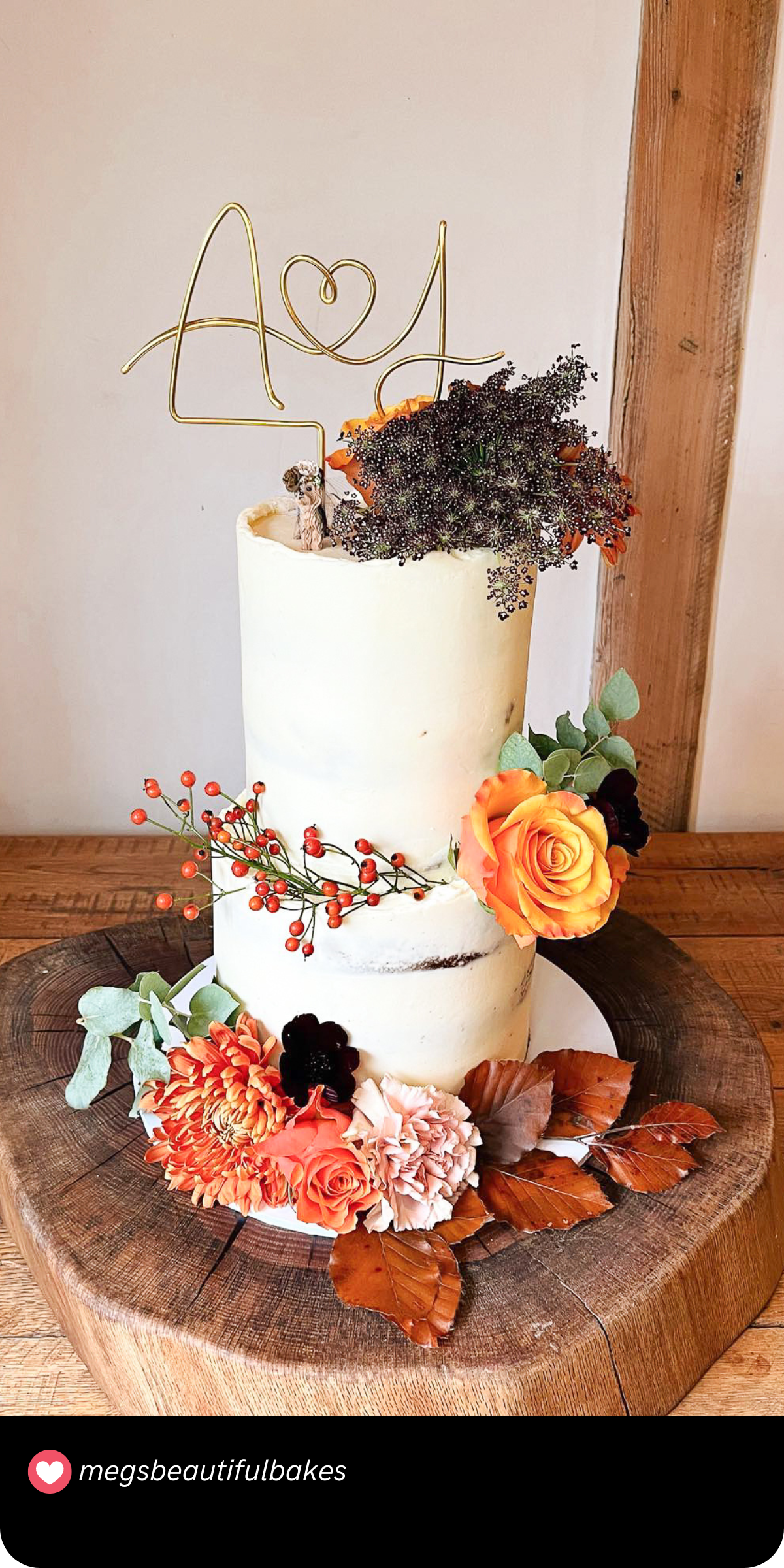 Rustic Fall Delight: This cake showcases the best of autumn with its rustic charm, adorned with warm-toned flowers and leaves, making it a delightful centerpiece for any fall wedding.