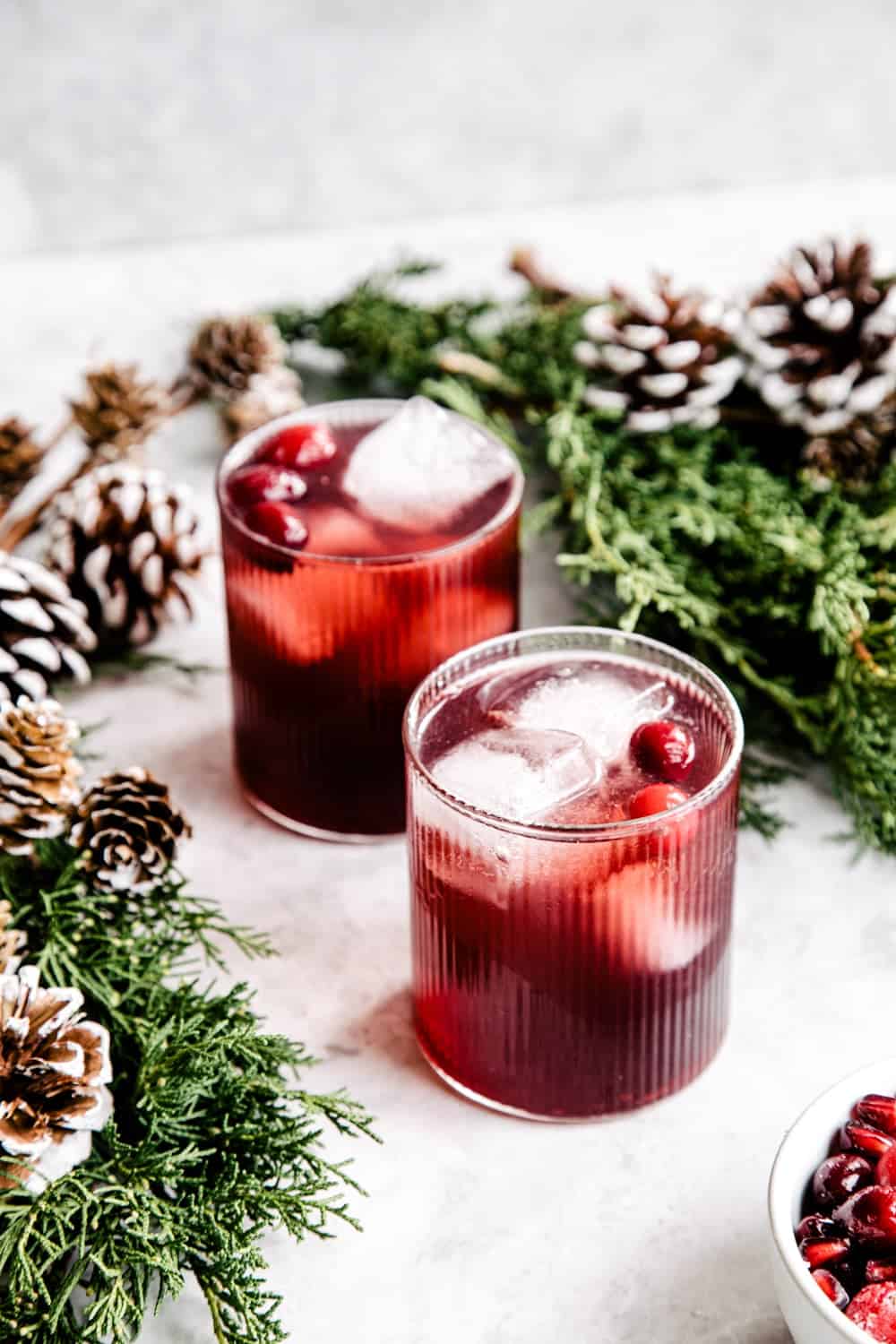 Add a holiday spin to a classic gin and tonic with rosemary sprigs, pomegranate seeds, and a splash of cranberry juice. A simple yet stunning Christmas party cocktail.