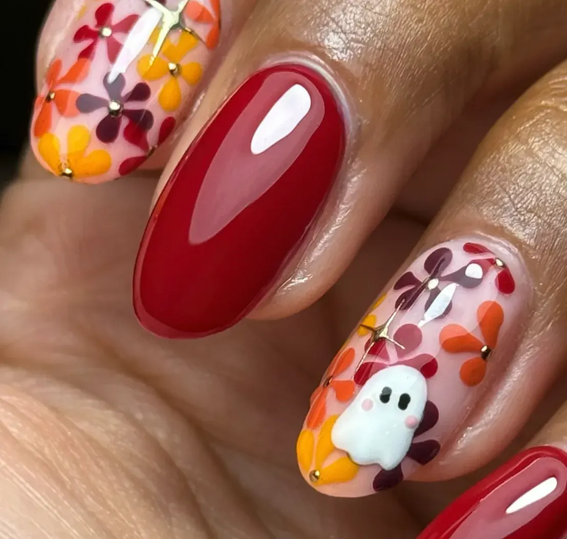 6. Fall Florals + Ghosts 🍂👻This one feels like Halloween walked through an autumn meadow. Bold red nails are paired with transparent floral designs in cozy October shades of orange, yellow, and burgundy—oh, and a little ghost peeking through like it belongs in the pumpkin patch. It’s a chic mix of fall vibes and spooky season inspo.
