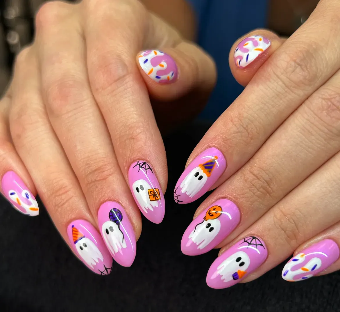 3. Party-Ready Ghosts 🎉👻These ghosts came ready for trick-or-treating! On a candy-pink base, you’ve got sweet little ghosties holding balloons, candy, and even rocking party hats. Add in spiderweb details and sprinkle accents, and you’ve got a cheerful October manicure that’s all about Halloween fun (without the scare factor).