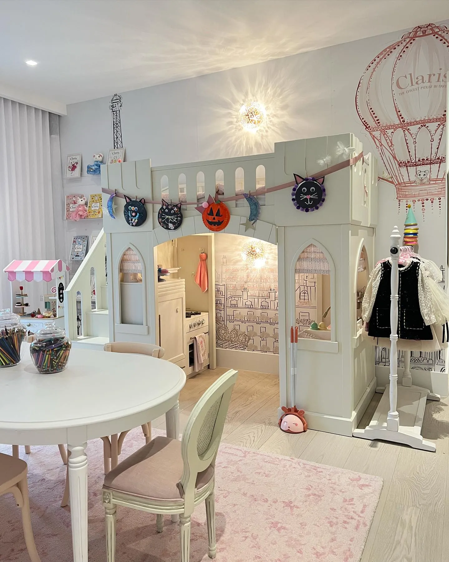 Princess Castle Playhouse – This enchanting playroom features a custom-built castle loft with a play kitchen underneath, a mini market, and soft pastel decor fit for royalty.