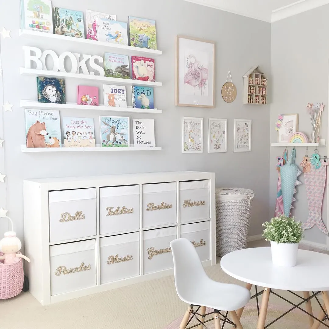 Soft & Serene Storytime Corner – A dreamy reading nook with labeled storage bins, floating bookshelves, and soft pastel decor to make tidying up easy and reading extra inviting.