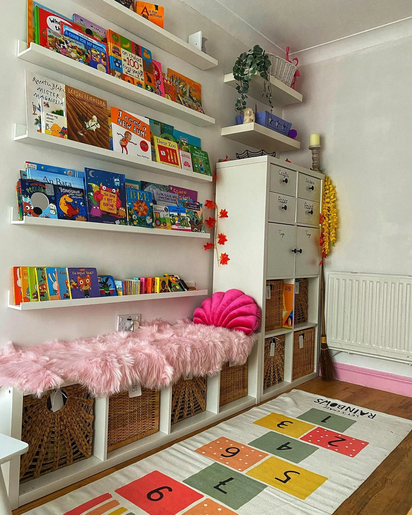 Colorful & Cozy Book Nook – A vibrant reading corner with floating shelves, cozy seating, and a hopscotch rug to bring fun and function together.