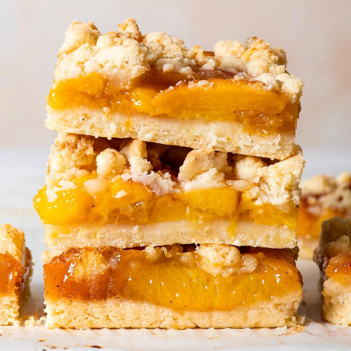 These gluten free peach crumble bars combine a buttery lemon shortbread with a juicy peach filling. They’re incredibly easy to make and they’re absolutely heavenly served with a dollop of vanilla ice cream. And you’d never know that they’re both gluten and egg free!!