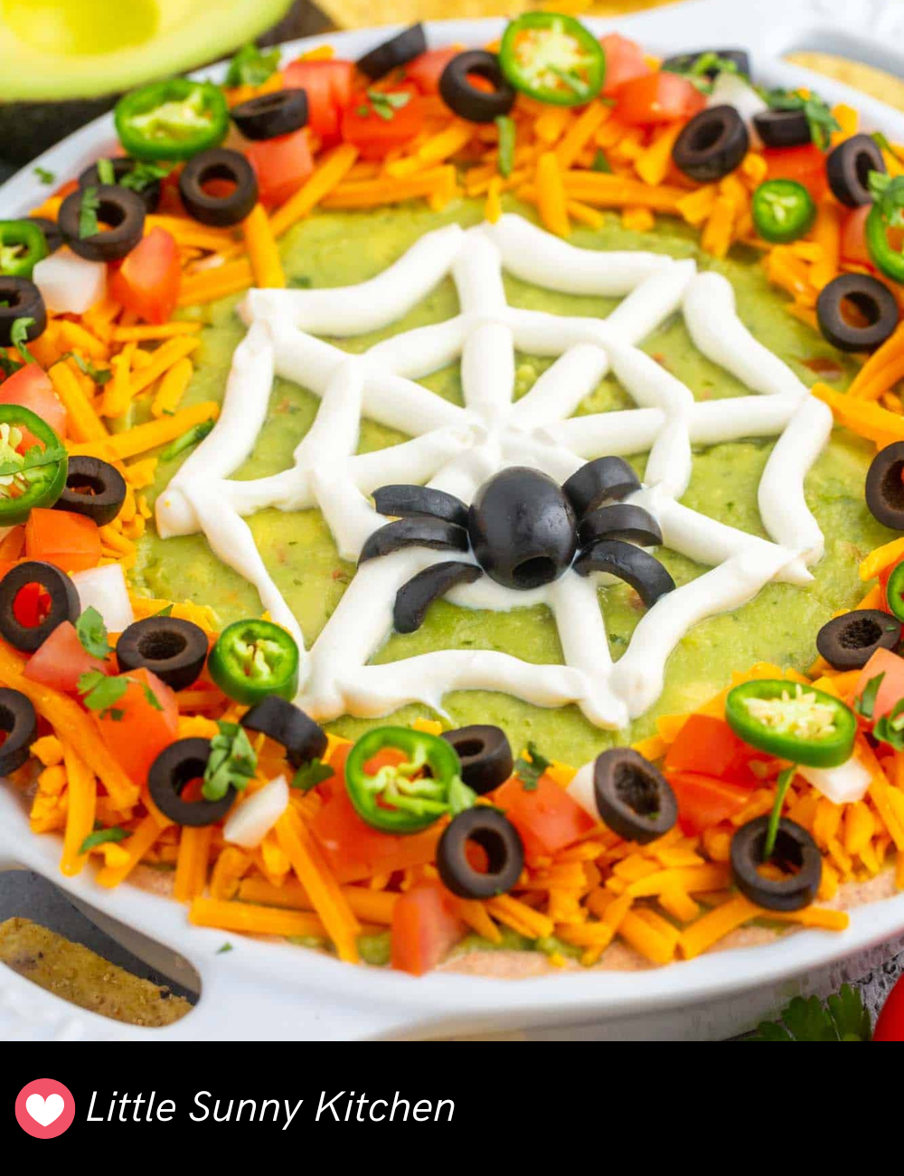 Your guests will love dipping into this Halloween Taco Dip! Layered with all your favorite taco toppings and decorated with a spooky web of sour cream, this dip is as festive as it is delicious. It’s the perfect finger food to keep everyone satisfied at your Halloween party.