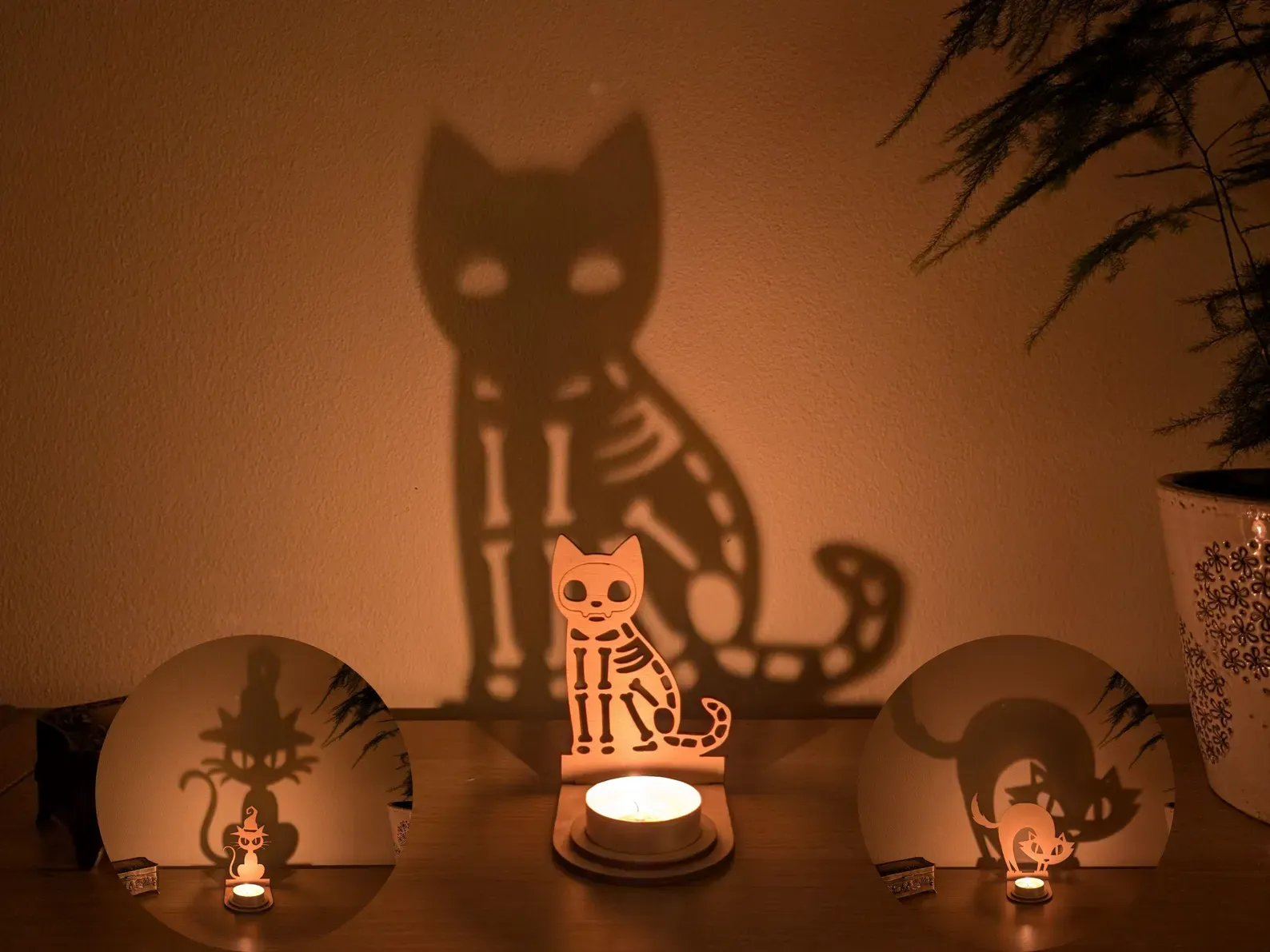 This skeleton cat tealight holder is pure Halloween magic. 🕯️🐈 Place a candle inside and watch as a haunting silhouette comes to life on your walls—spooky, flickering, and impossible not to stare at. Made from birch plywood and designed to fit a standard tealight, it’s a simple way to add eerie ambiance to your Halloween décor. Perfect for parties, trick-or-treater thrills, or even as a year-round gothic accent, this shadow caster is as enchanting as it is spooky. A fabulous little gift for any Halloween lover—or the finishing touch your haunted setup has been waiting for. 🎃✨